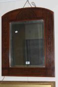 Arched poker work framed bevelled wall mirror