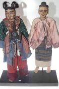 Pair of period dressed Indonesian wooden puppets,