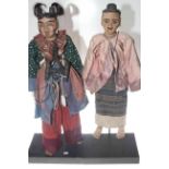 Pair of period dressed Indonesian wooden puppets,