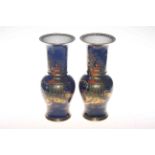 Carlton Ware pair of chinoiserie vases on a blue background,