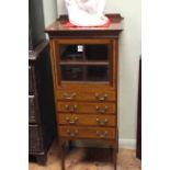 Edwardian mahogany and satinwood banded music cabinet having a glazed panel door above four drawers,
