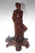 Oriental hardwood carved figure of a robed gentleman,