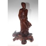 Oriental hardwood carved figure of a robed gentleman,