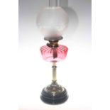 Late Victorian ornate oil lamp with ruby glass reservoir and etched glass shade,