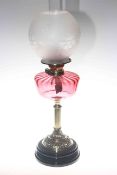 Late Victorian ornate oil lamp with ruby glass reservoir and etched glass shade,