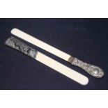 Two embossed silver handled ivory page turners,