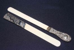 Two embossed silver handled ivory page turners,