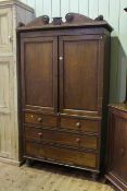 Victorian oak and mahogany linen press having two doors above four drawers on turned legs,