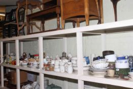 Full shelf of china, teaware, dinnerware, storage jars, planters, ornaments,