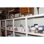 Full shelf of china, teaware, dinnerware, storage jars, planters, ornaments,