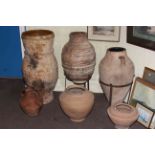 Collection of earthenware style garden pots and planters