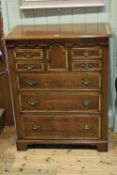 Good quality oak and satinwood banded chest having seven drawers and arched cupboard door,