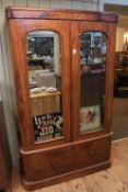 Victorian mahogany wardrobe having two mirror panelled doors above a deep drawer,