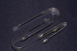 Two pairs of Newcastle silver sugar tongs and another (3)