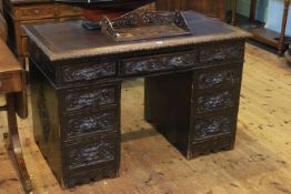 Carved oak nine drawer pedestal desk,