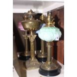 Four brass column oil lamps,