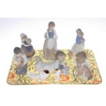 Lladro and five Nao figures and two Royal Doulton dogs