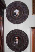 Pair of porcelain portrait plaques in embossed metal frames,