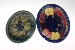 Moorcroft plate decorated with plum and leaves on blue ground,