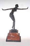 Lady bronze with outstretched arms on a marble plinth,