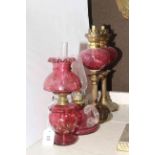 Four small ruby glass and brass oil lamps