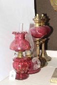 Four small ruby glass and brass oil lamps