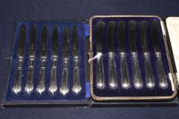 Two sets of six silver handled dessert knives,