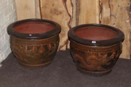 Pair of large terracotta planters decorated with dragons