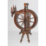 Walnut spinning wheel with turned spindles