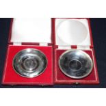 Two Churchill sterling silver commemorative Crown reversible dishes, in boxes, one with certificate,