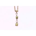 Triple peridot pendant on gold rope twist necklace