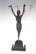 Bronze lady posed with outstretched arms on a marble plinth,