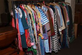 Rail of vintage clothing including dresses, coats, jackets,