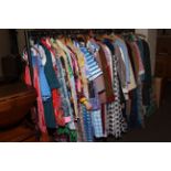 Rail of vintage clothing including dresses, coats, jackets,