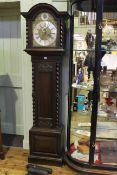 Early 20th Century carved oak triple weight longcase clock having arched brass and silvered dial