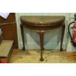 Early 20th Century mahogany demi lune fold top card table on ball and claw legs,