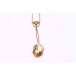 Gold chain with pearl drop and pale yellow stone pendant