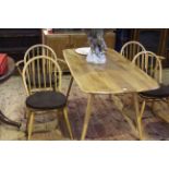 Ercol Windsor six piece dining suite comprising three door sideboard, rectangular dining table,