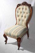 Victorian carved mahogany nursing chair in striped buttoned fabric