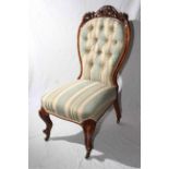 Victorian carved mahogany nursing chair in striped buttoned fabric