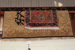 Black ground border carpet 3.00 by 1.90 and Indian rust ground rug 1.50 by 0.