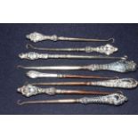 Eight silver button hooks