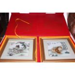 Two Oriental cased plaques decorated with Pekingese dogs,