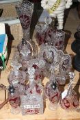 Collection of bird decorated ruby and clear glassware including vases, bells, dishes, trinket ware,