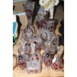 Collection of bird decorated ruby and clear glassware including vases, bells, dishes, trinket ware,