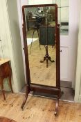 Late 19th Century/early 20th Century mahogany cheval mirror raised on four outsplayed legs,