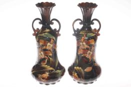 Pair of Continental two handled vases decorated with flowers,