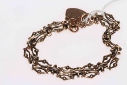 Gold link bracelet with heart shaped lock