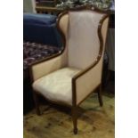 Edwardian mahogany and line inlaid wing back armchair in pink foliate pattern fabric