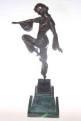 Bronze lady in dancing pose on green marble plinth,